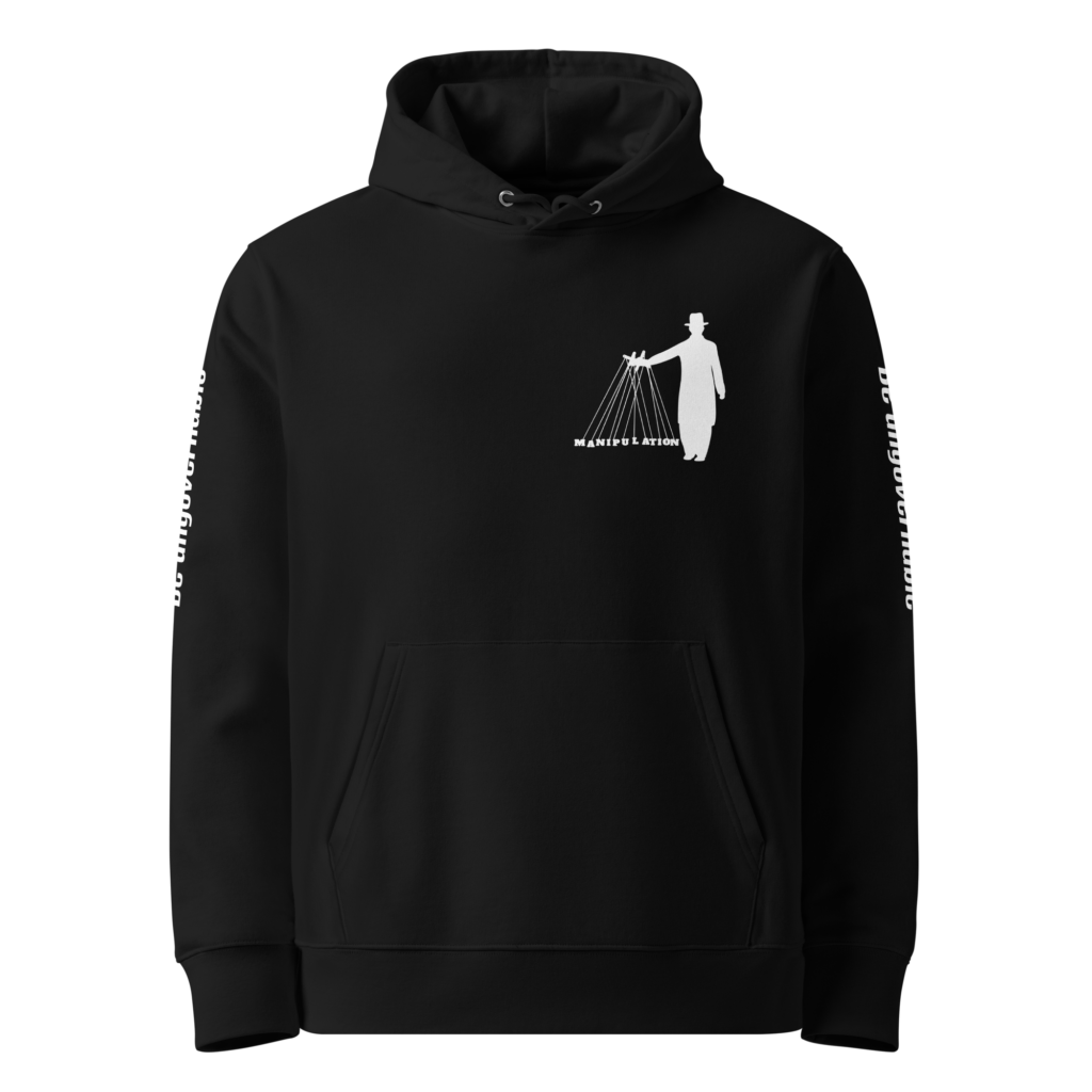 Voorkant van zwarte unisex hoodie met marionettenspeler 'Manipulation' print op de borst en 'Be ungovernable' tekst op beide mouwen — anti-systeem statement hoodie van biologisch katoen.